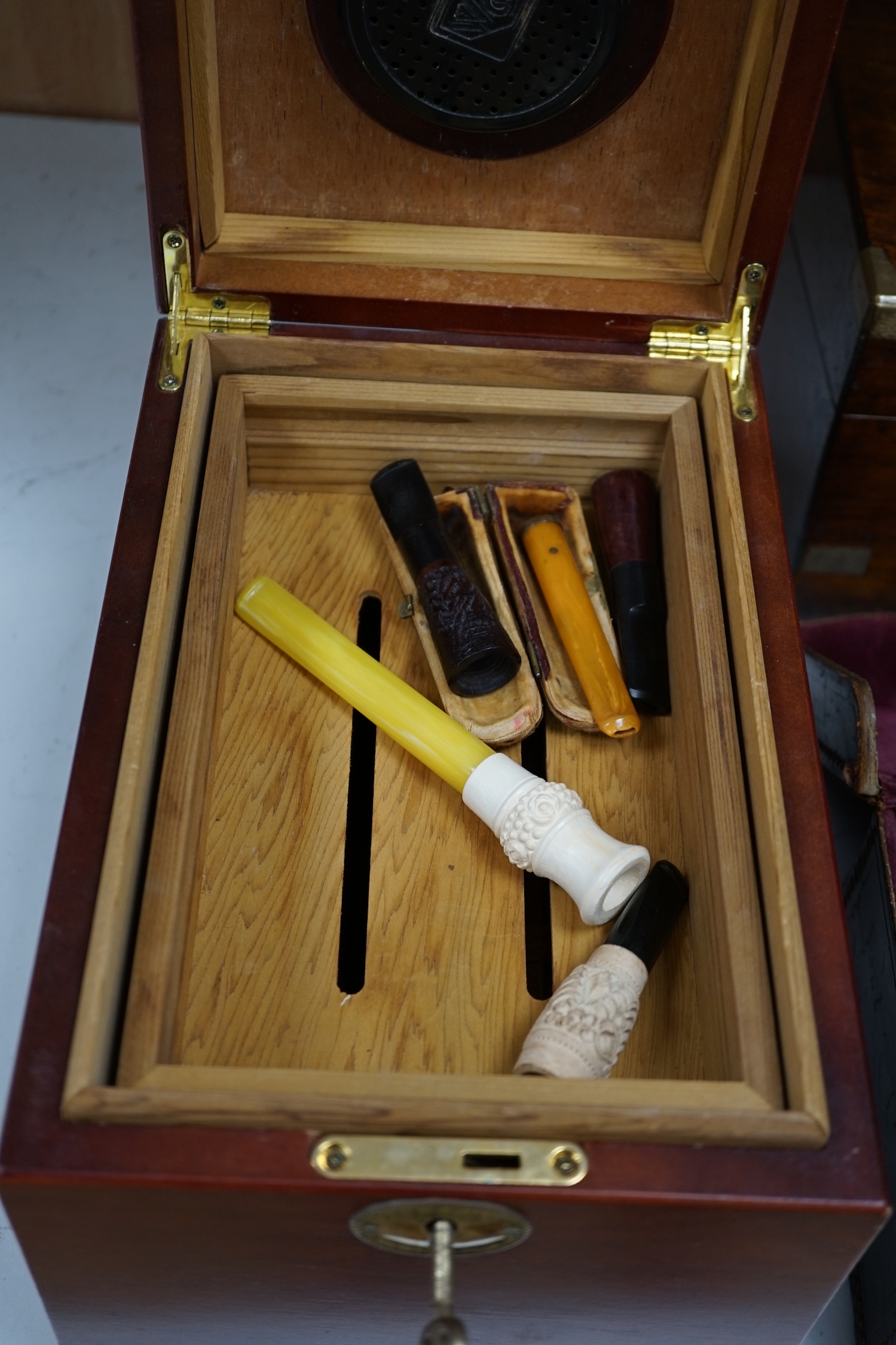 A writing slope, humidor and contents including a silver mounted cigar case, an Evans Electroselenium Ltd. light meter and a Weston Voltmeter. Condition - fair.